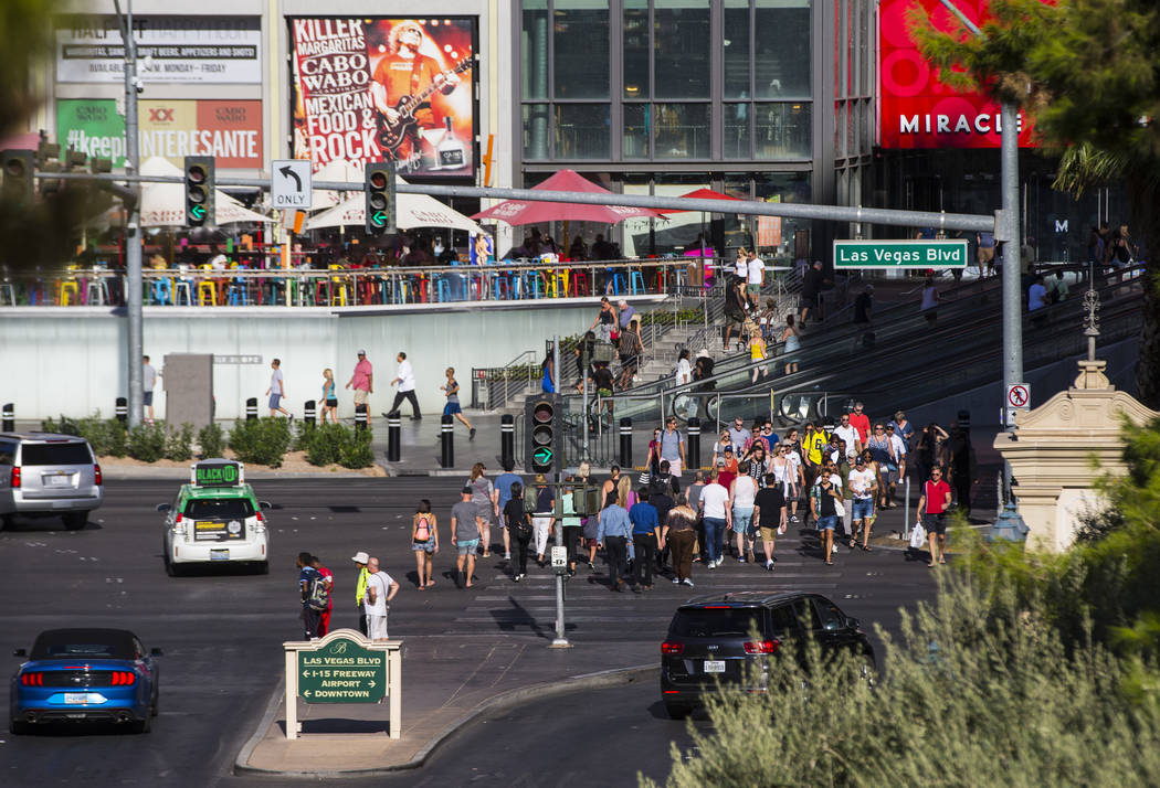 Visitors crowd the Las Vegas Strip outside of the Miracle Mile Shops as people arrive for the L ...