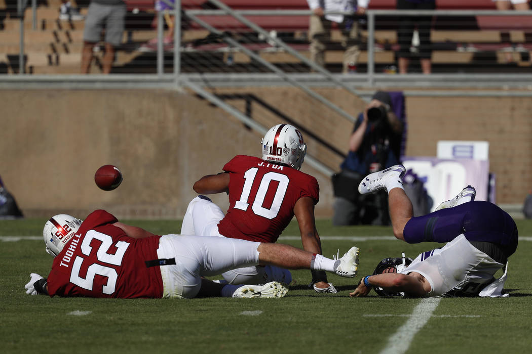 Stanford linebacker Casey Toohill (52) and Stanford linebacker Jordan Fox (10) cause a fumble a ...