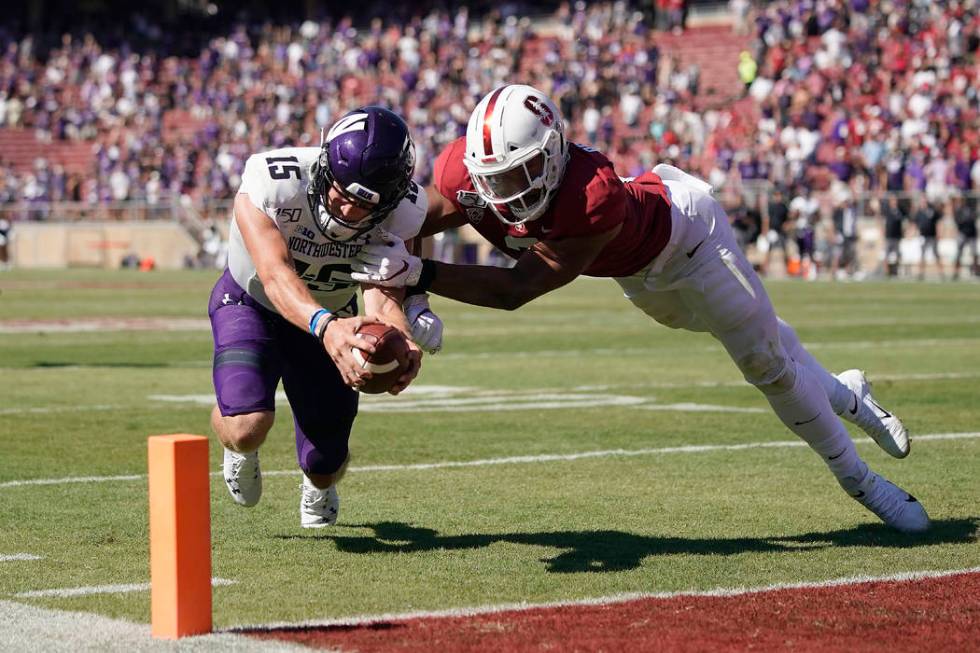 Northwestern quarterback Hunter Johnson (15) is stopped short of the end zone by Stanford lineb ...