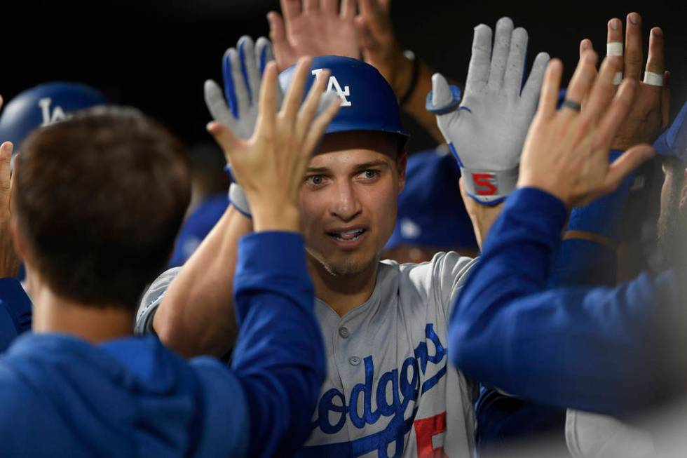 Los Angeles Dodgers' Corey Seager is congratulated in the dugout for his three-run home run dur ...