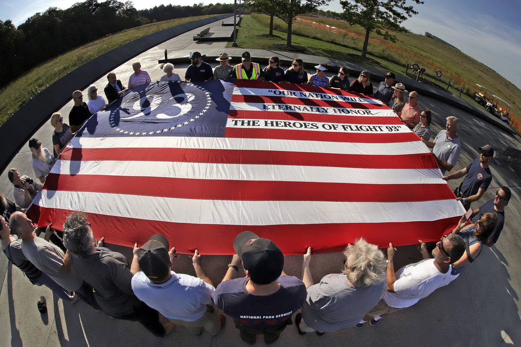 Visitors to the Flight 93 National Memorial in Shanksville, Pa., participate in a sunset memori ...