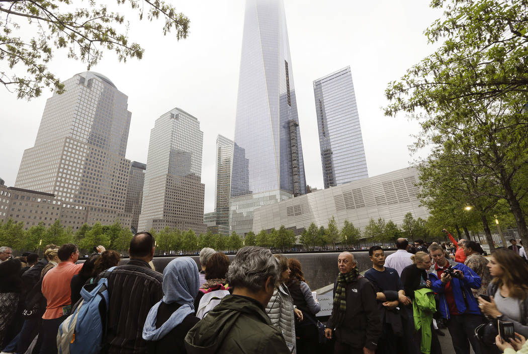 FILE- In this May 15, 2015 file photo, visitors gather near the pools at the 9/11 Memorial in N ...