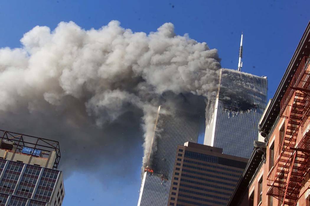 FILE - In this Sept. 11, 2001, file photo, smoke rises from the burning twin towers of the Worl ...