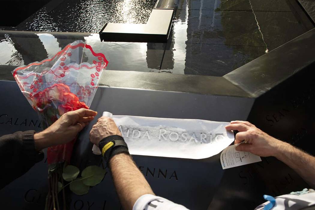 Louis Gonzalez makes a rubbing of his sister's name at the National September 11 Memorial, Wedn ...