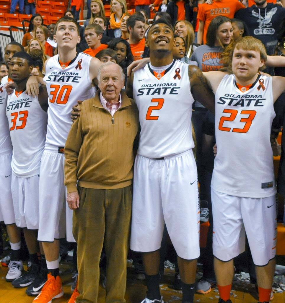 In a March 2, 2013, file photo, oil tycoon and Oklahoma State supporter T. Boone Pickens, cente ...