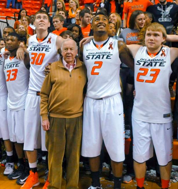 In a March 2, 2013, file photo, oil tycoon and Oklahoma State supporter T. Boone Pickens, cente ...