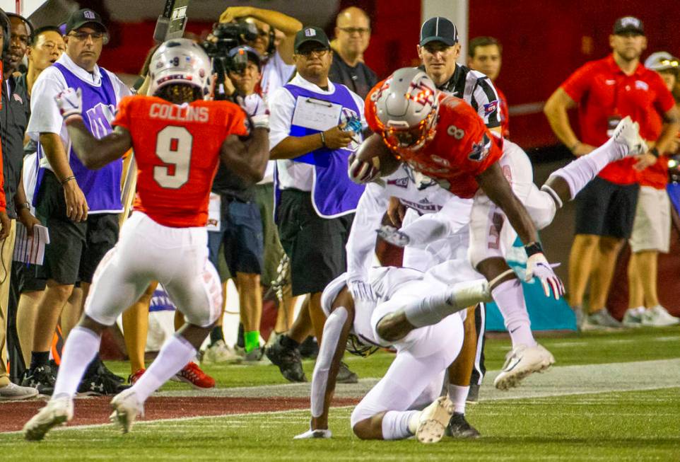 UNLV Rebels running back Charles Williams (8) is upended on a run over Southern Utah in the fir ...