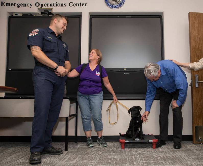 Las Vegas Fire and Rescue firefighter/paramedic Tony Brown, left, shares a laugh with Linda Sla ...