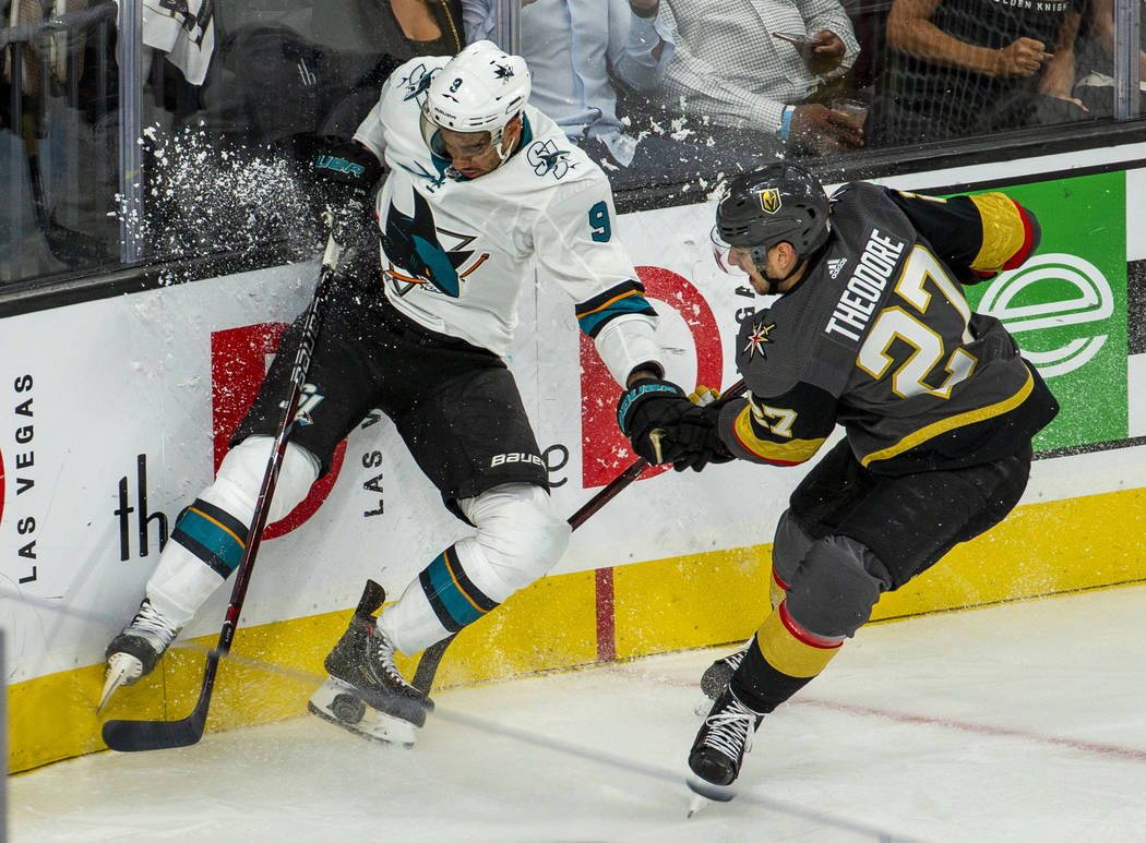 San Jose Sharks left wing Evander Kane (9) crashes the boards with Golden Knights defenseman Sh ...