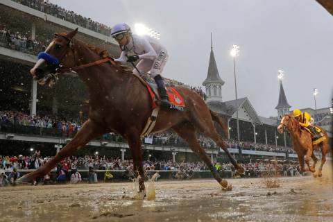 Mike Smith rides Justify to victory during the 144th running of the Kentucky Derby horse race a ...