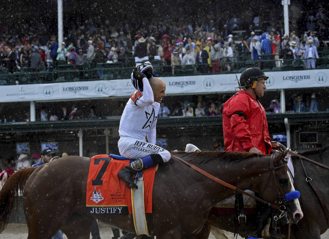 Jockey Mike Smith smiles after riding Justify to win the 144th running of the Kentucky Derby, t ...