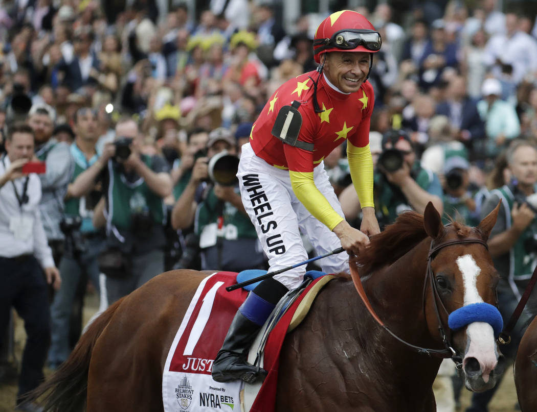 In this June 9, 2018, file photo, jockey Mike Smith celebrates riding Justify to win the 150th ...