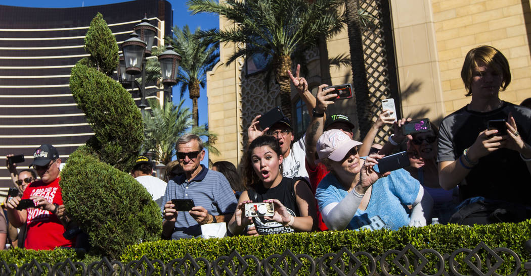Fans clamor to take pictures of Kyle Busch outside of The Palazzo during the NASCAR America Bur ...