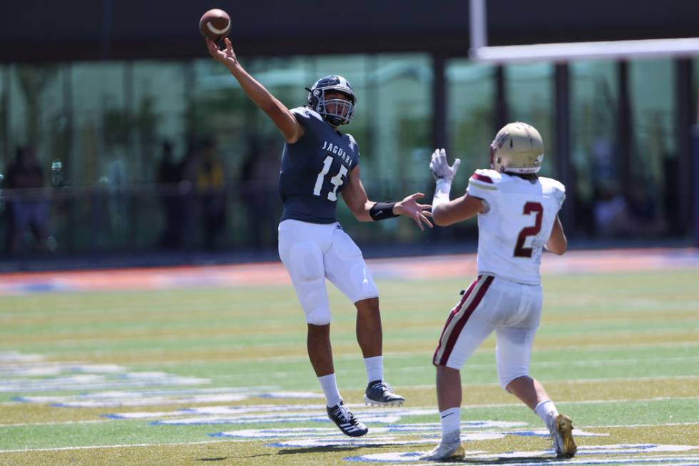 Desert Pines' Rjay Tagatases (15) throws the ball under pressure from Logan's Chris Shopbell (2 ...