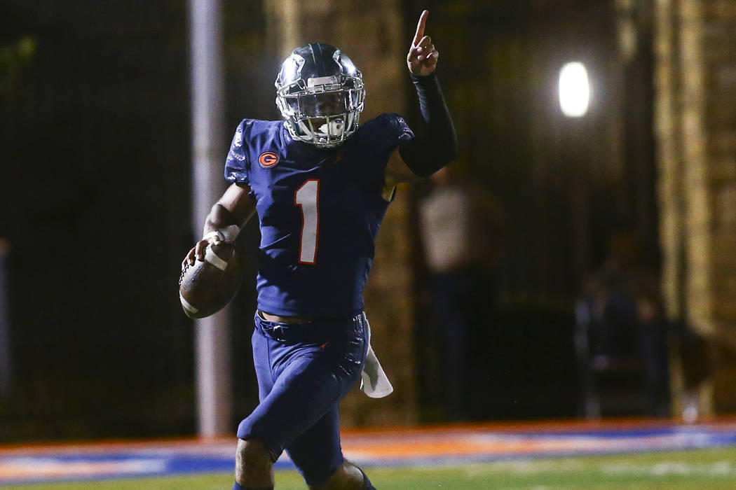 Bishop Gorman's Micah Bowens (1) motions to teammates during the first half of a football game ...