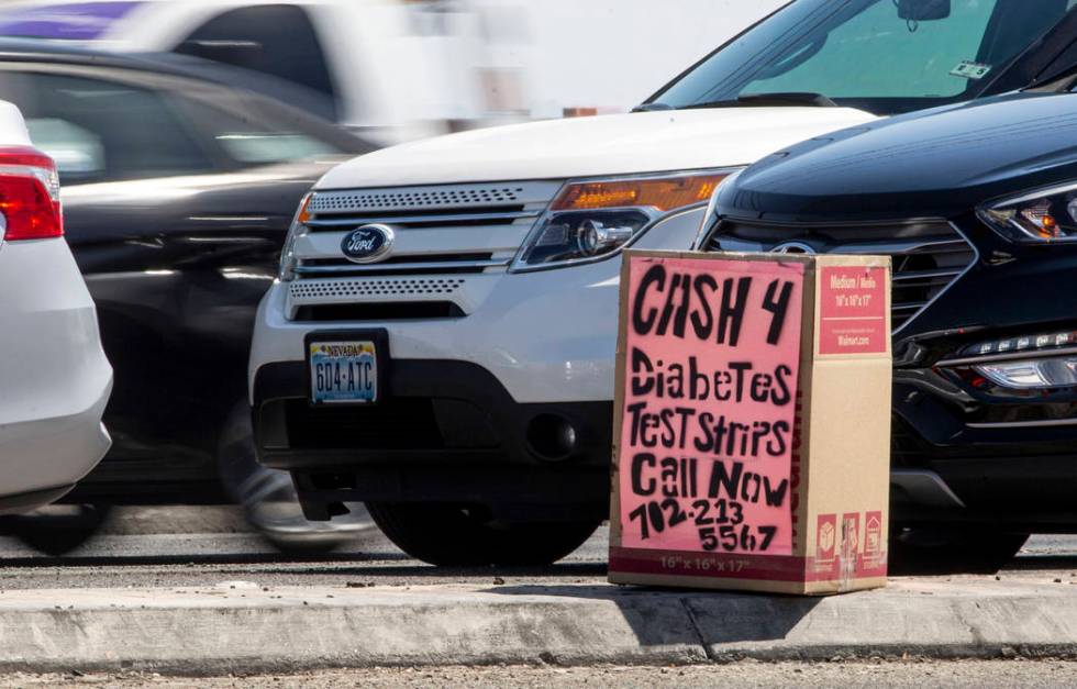 A box offering cash for diabetes testing strips is seen on West Cheyenne Avenue and North Marti ...