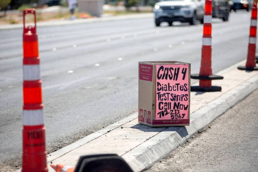 A box offering cash for diabetes testing strips is seen on West Cheyenne Avenue and North Marti ...