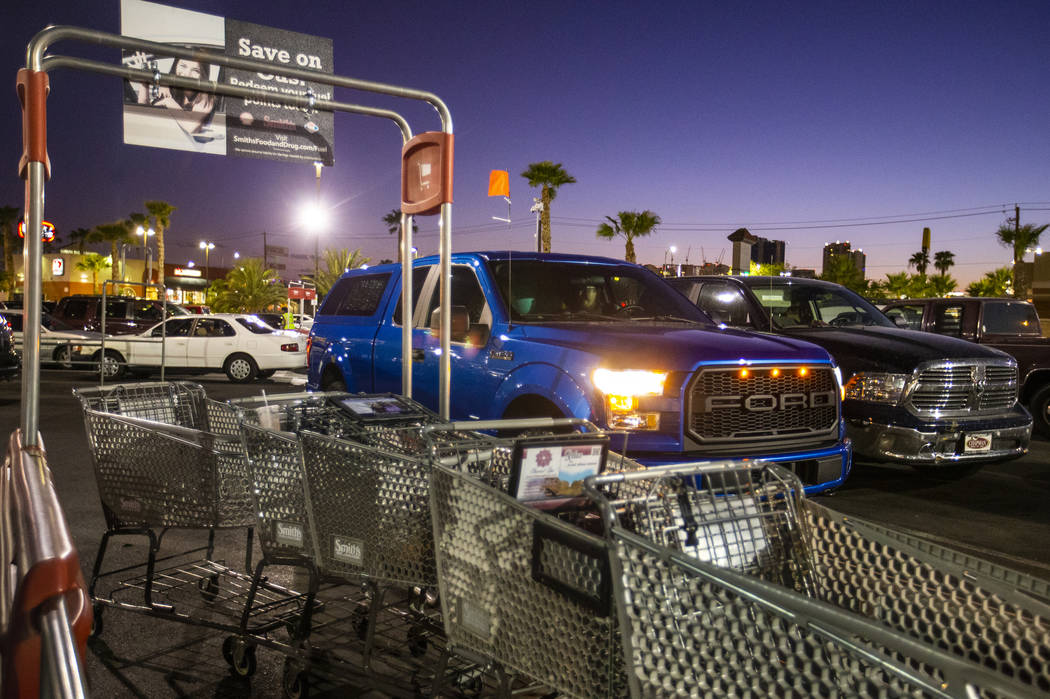 A blue truck in a supermarket parking lot transports guests to the secret Oakey Family Supper C ...