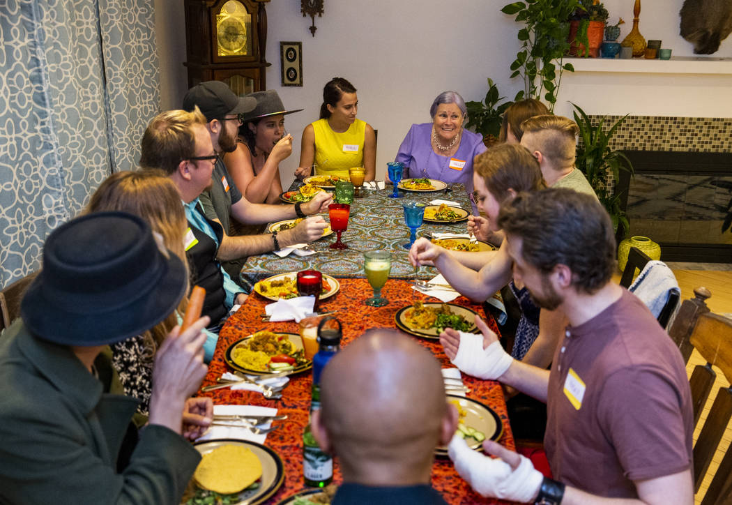 Guests enjoy a meal and conversation during the Oakey Family Supper Club event on Monday, Sept. ...