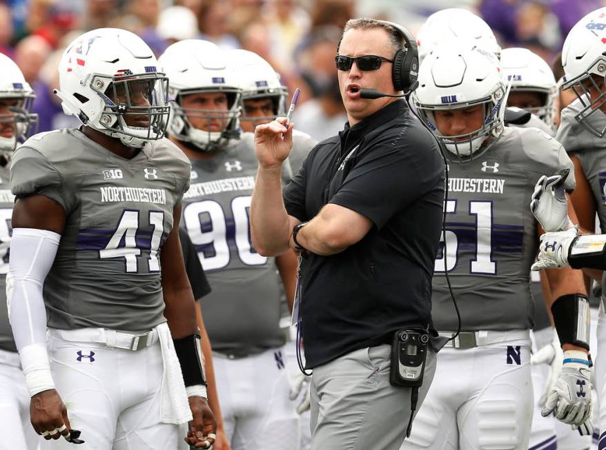 In this Saturday, Sept. 8, 2018, file photo, Northwestern coach Pat Fitzgerald speaks with his ...