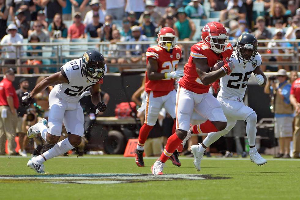 Kansas City Chiefs wide receiver Sammy Watkins, front right, runs past Jacksonville Jaguars def ...