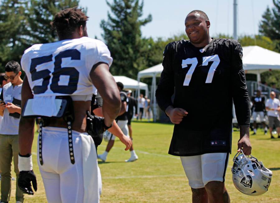 Oakland Raiders offensive tackle Trent Brown (77) meets with Los Angeles Rams defensive end Dan ...