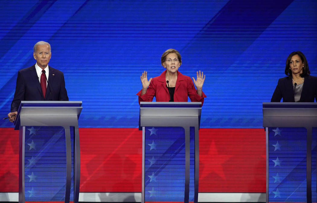 Former Vice President Joe Biden, left, and Sen. Kamala Harris, D-Calif., right, listen as Sen. ...