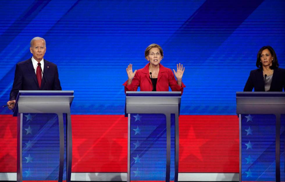 Former Vice President Joe Biden, left, and Sen. Kamala Harris, D-Calif., right, listen as Sen. ...