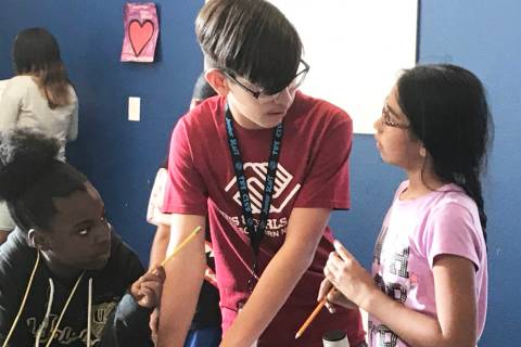 Woodbury Middle School eighth-grader Jordan Cobos, 13, helps children with a fire safety worksh ...