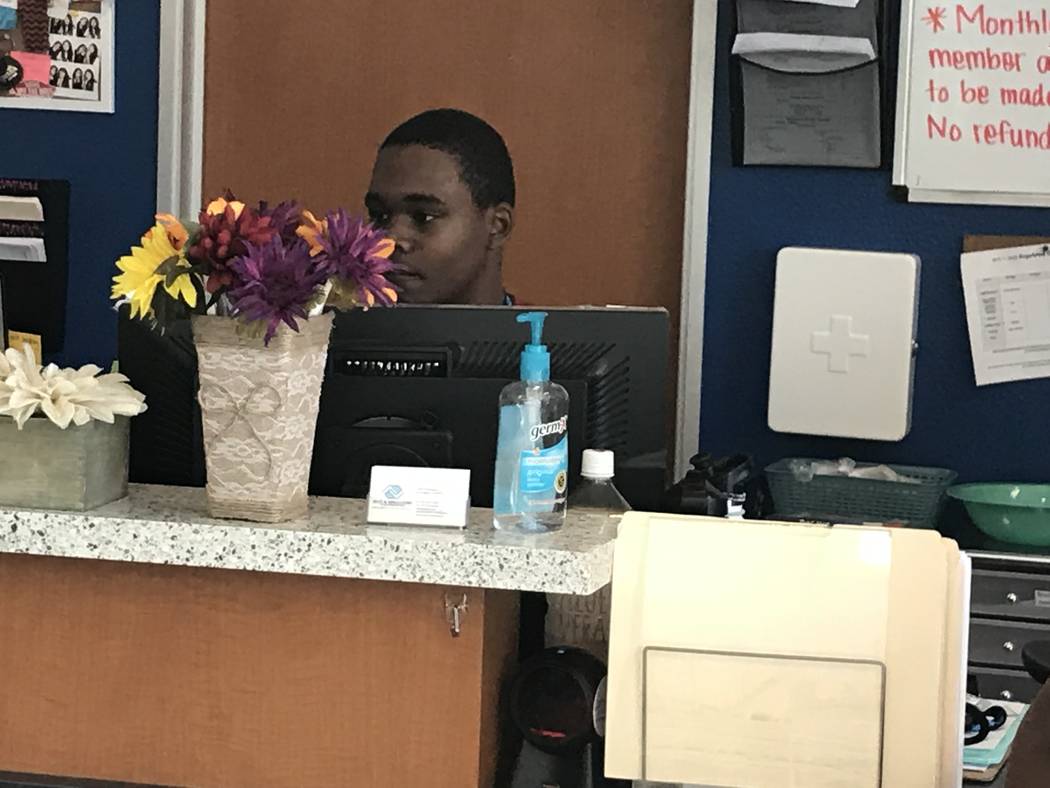 Valley High School sophomore Tyrese Jackson, 15, helps at the front desk Sept. 12 at the Ralph ...