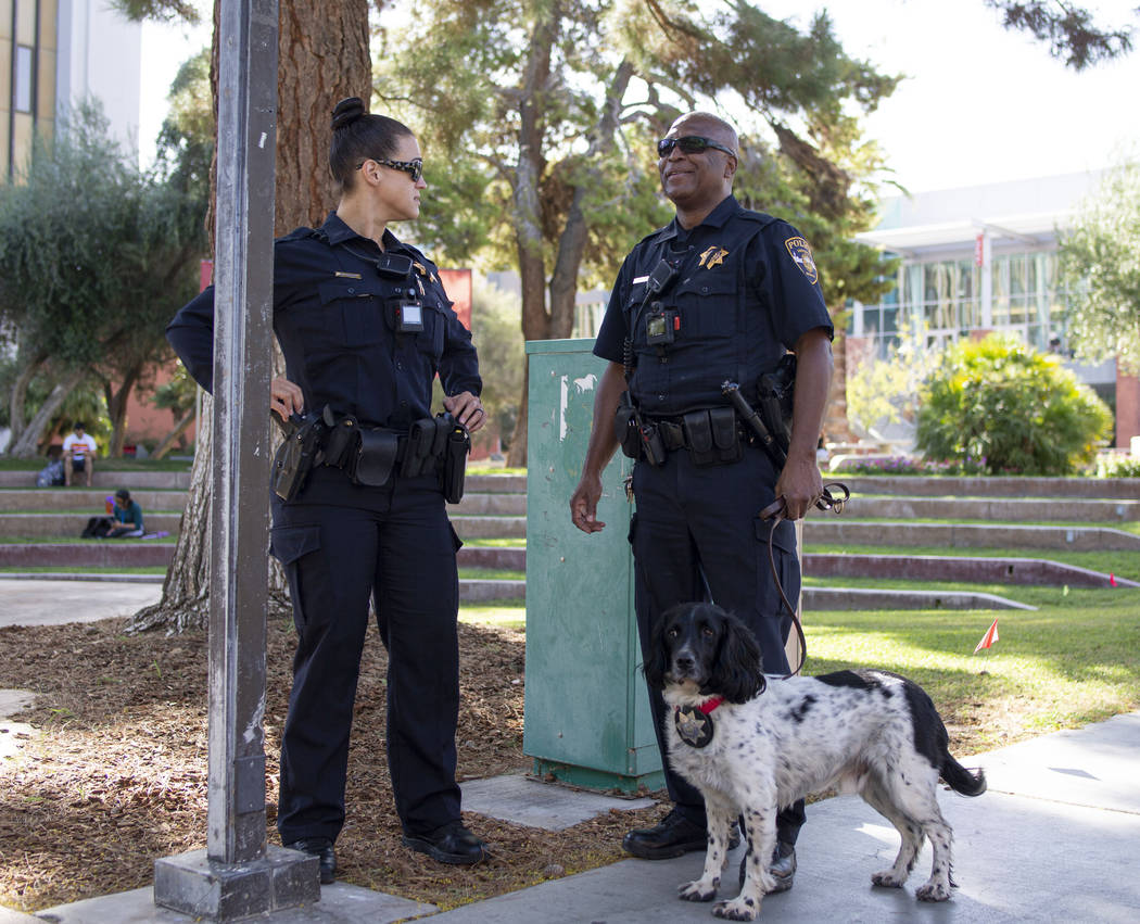 University Police Services officer Bree Torrey, left, and officer Darrell Johnson with K9 Buste ...
