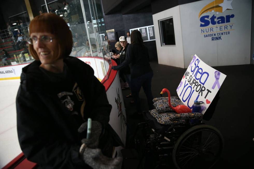 Shannon Walker watches a Vegas Golden Knights team practice with a sign in support of Vegas Gol ...