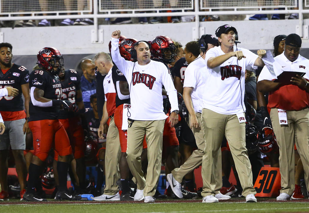 UNLV Rebels head coach Tony Sanchez motions to his team during the second half of an NCAA foot ...