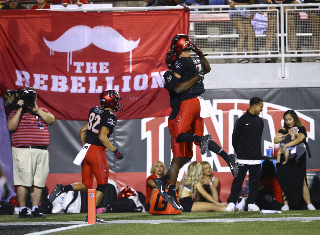 UNLV Rebels wide receiver Randal Grimes celebrates his touchdown with quarterback Kenyon Oblad ...