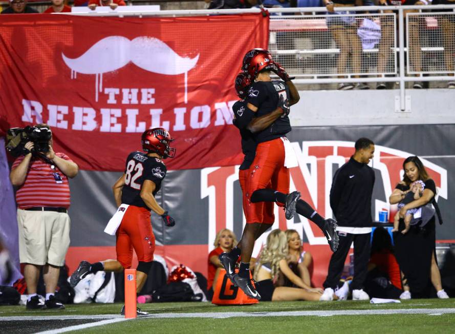 UNLV Rebels wide receiver Randal Grimes celebrates his touchdown with quarterback Kenyon Oblad ...