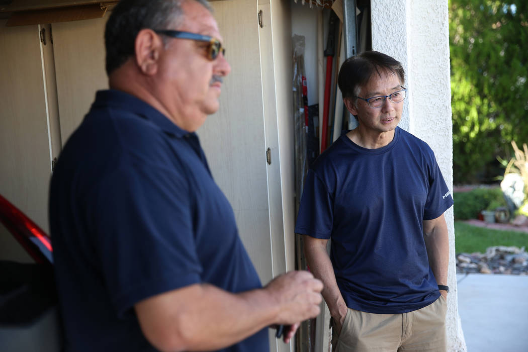 Victor Padron, left, in front of his home with his neighbor Wayne Niimi, talk about rehab cente ...