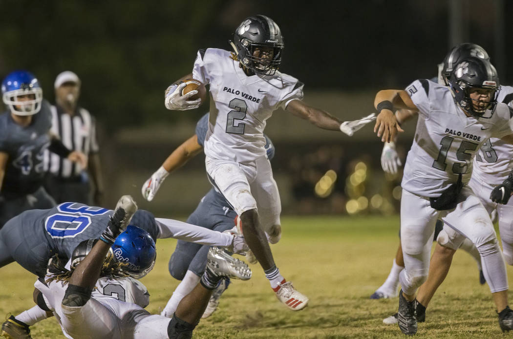 Palo Verde junior running back Charron Thomas (2) leaps through an open hole past Green Valley ...