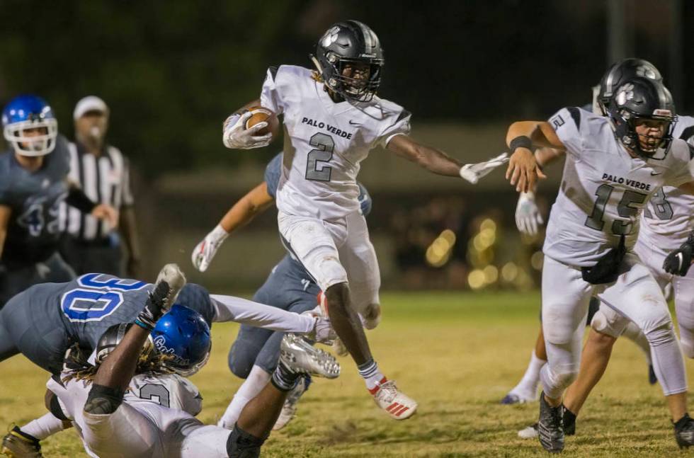 Palo Verde junior running back Charron Thomas (2) leaps through an open hole past Green Valley ...