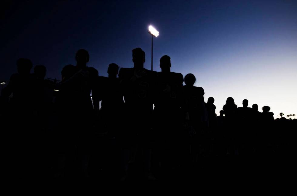 Green Valley players listen to the national anthem before the start of the Gators home matchup ...