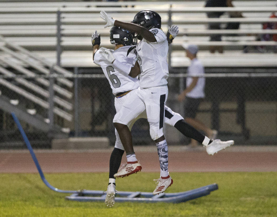 Palo Verde junior running back Charron Thomas (2) celebrates with teammate Dominic Romano (6) a ...