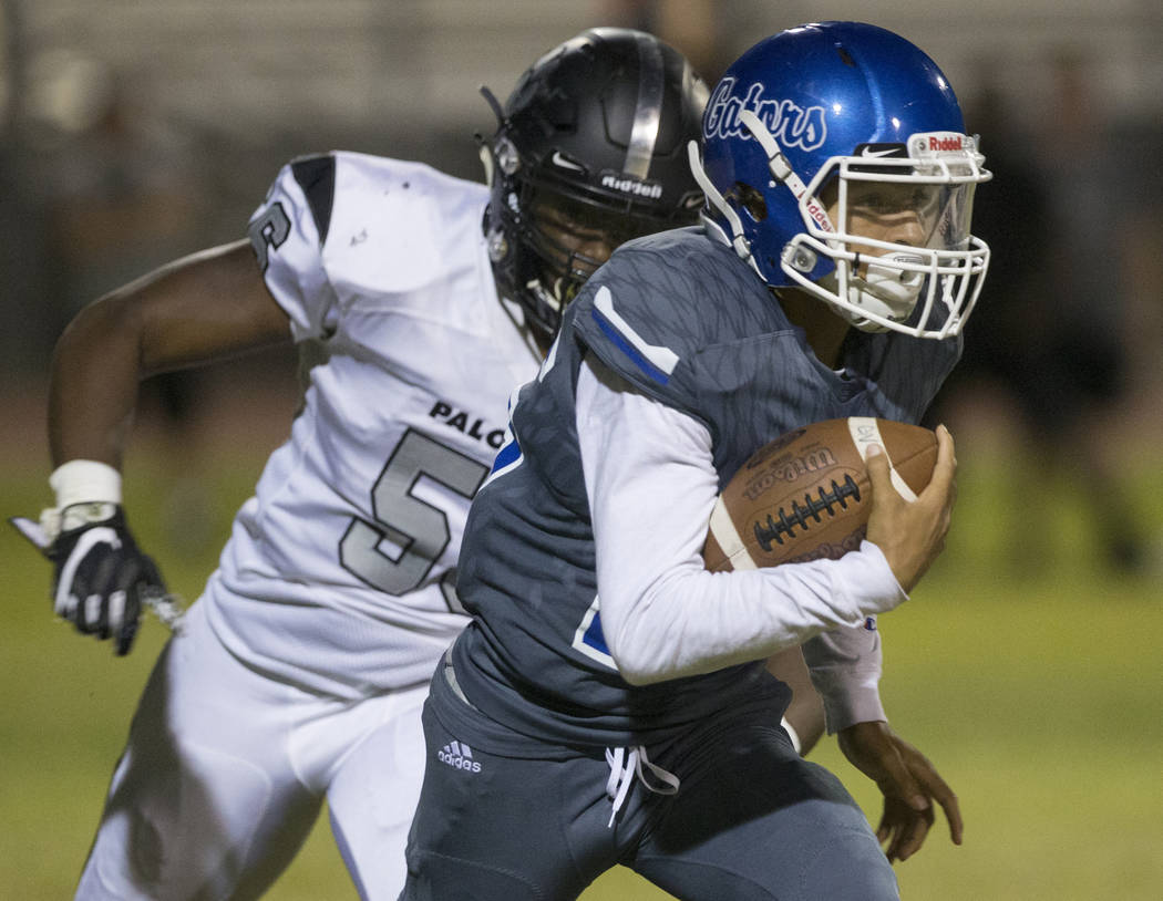 Green Valley freshman quarterback Anton Mazzulo (26) runs upfield past Palo Verde senior defend ...