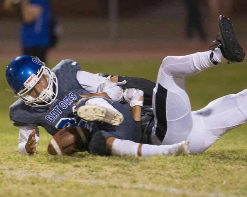 Green Valley freshman quarterback Anton Mazzulo (26) tries to recover a fumble with a Palo Verd ...