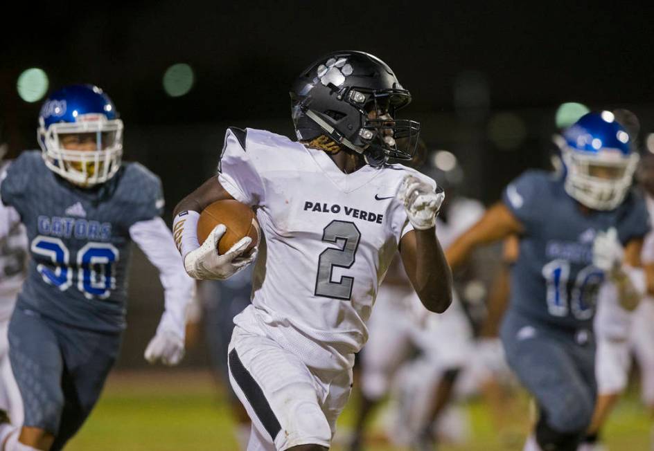 Palo Verde junior running back Charron Thomas (2) sprints up field past Green Valley defenders ...