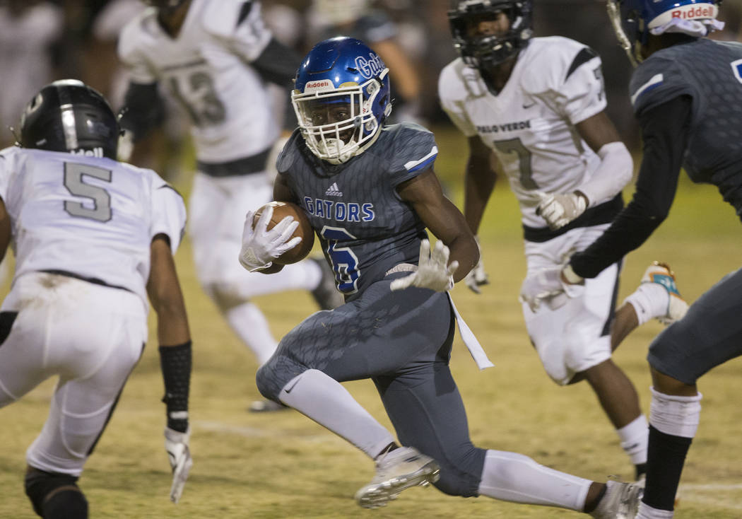 Green Valley senior running back Maaliek Duncan (6) breaks a big run past Palo Verde defenders ...