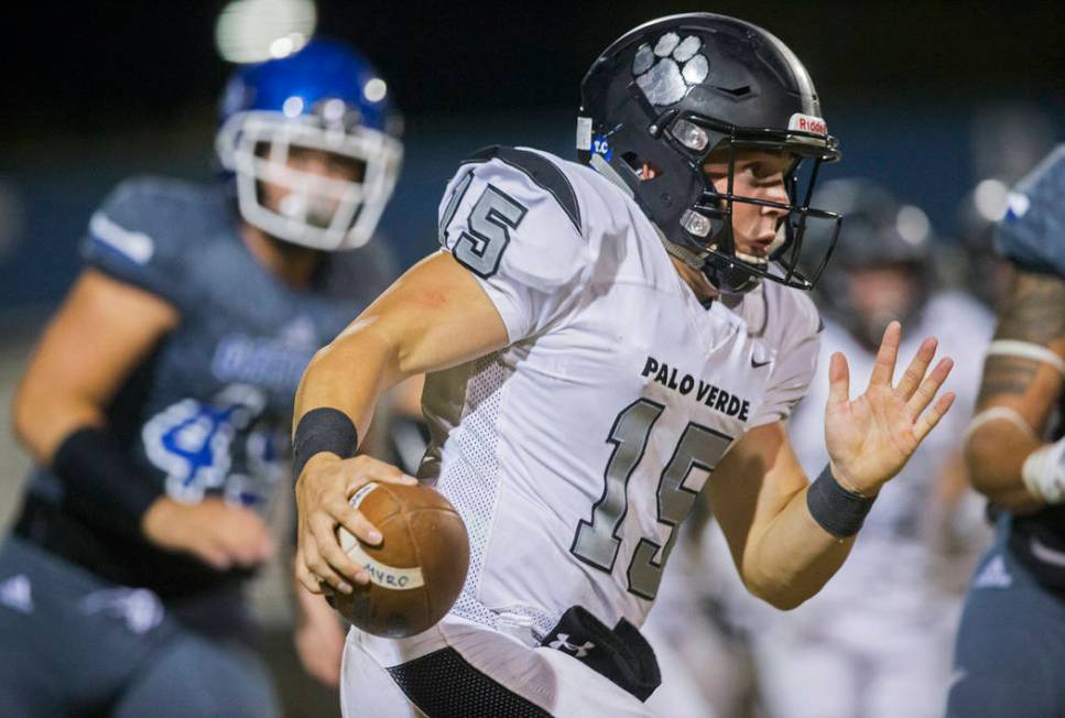 Palo Verde senior quarterback Paul Myro (15) sprints down the sideline past Green Valley senior ...