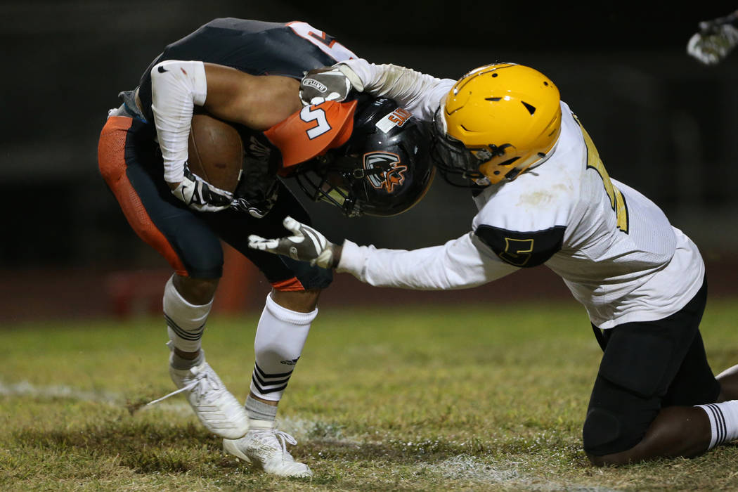 Chaparral's Steve Torres (5) is tackled after an intercepting the ball intended for Clark's Dar ...