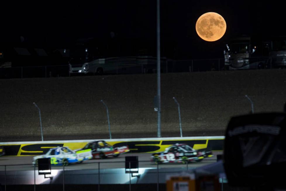 A harvest moon rises as drivers compete in the NASCAR World of Westgate 200 Truck Series auto r ...