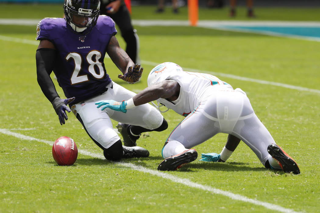 Miami Dolphins wide receiver Jakeem Grant (19) drops a punt return as Baltimore Ravens defensiv ...