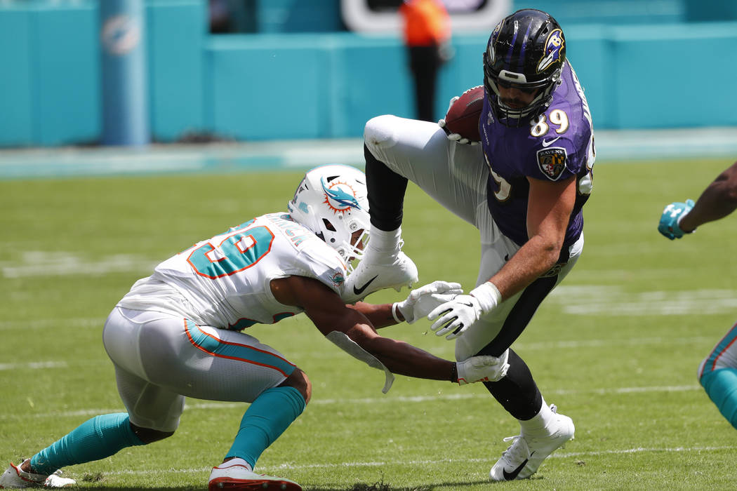 Miami Dolphins free safety Minkah Fitzpatrick (29) tackles Baltimore Ravens tight end Mark Andr ...