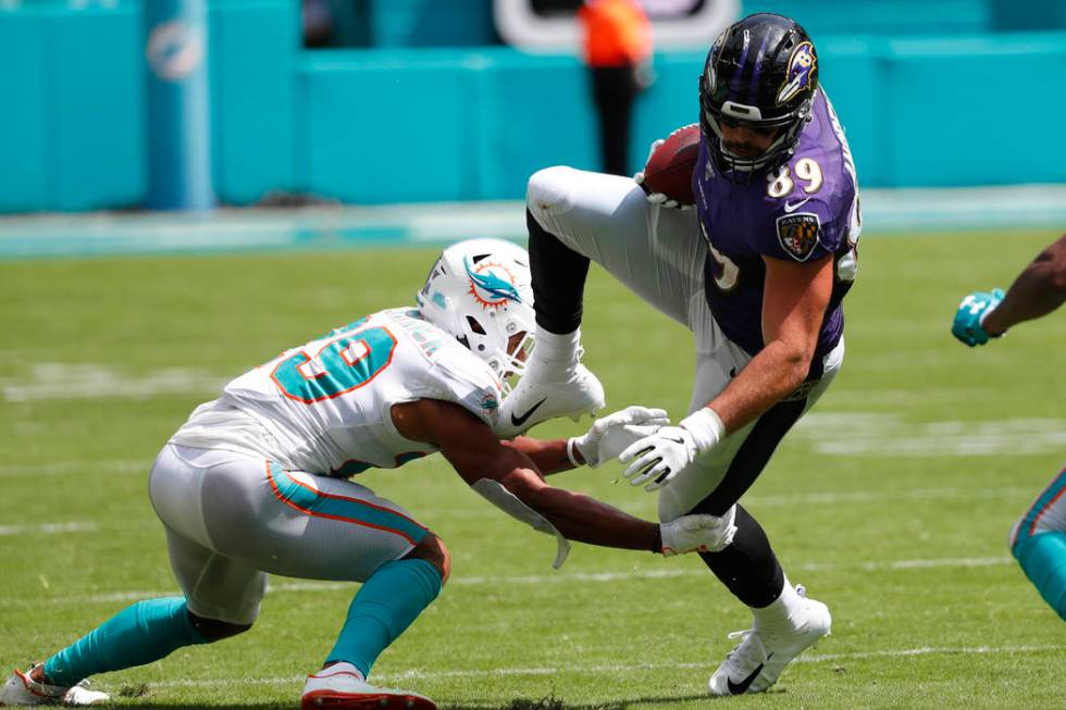 Miami Dolphins free safety Minkah Fitzpatrick (29) tackles Baltimore Ravens tight end Mark Andr ...